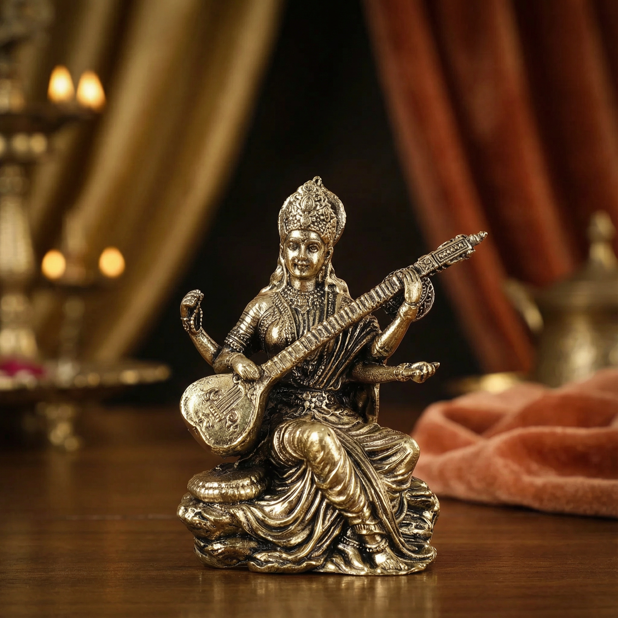 Bronze statue of a deity playing a stringed instrument on a wooden surface with warm lighting.
